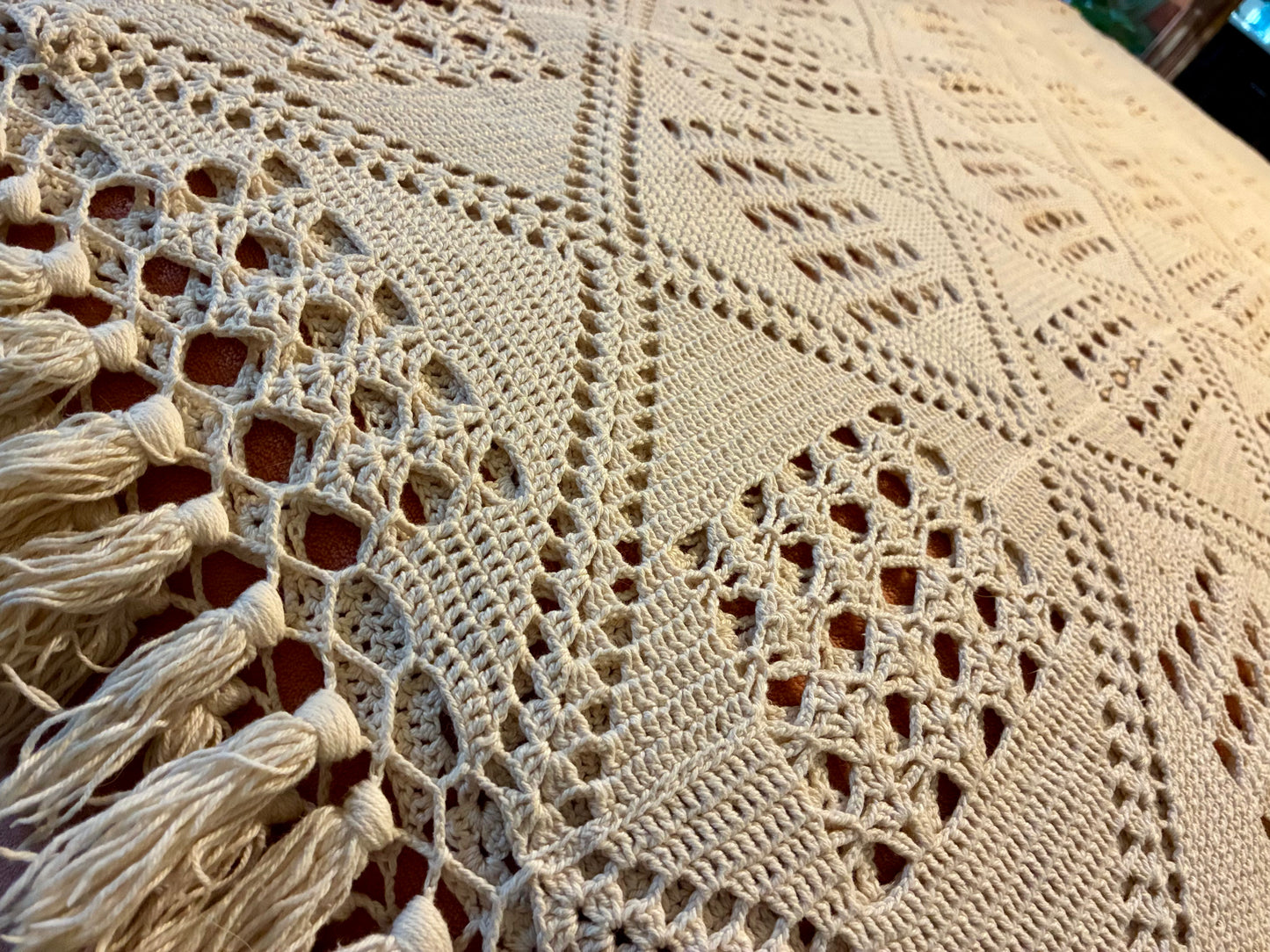 Crochet diamond pattern coverlet with fringe
