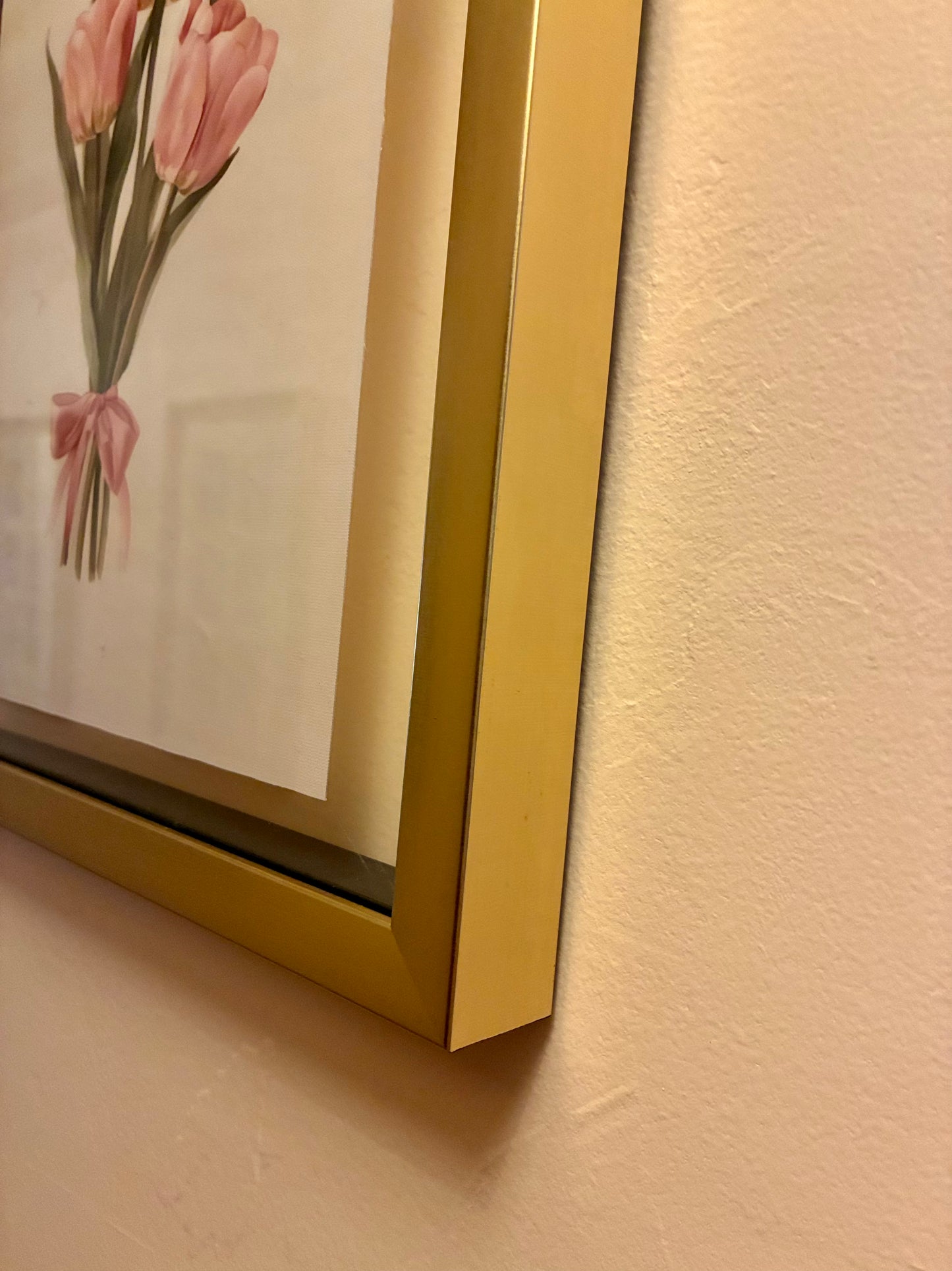 Pink tulips and ribbon canvas print in floating gold frame