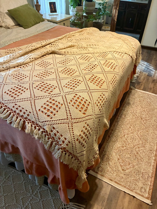 Crochet diamond pattern coverlet with fringe