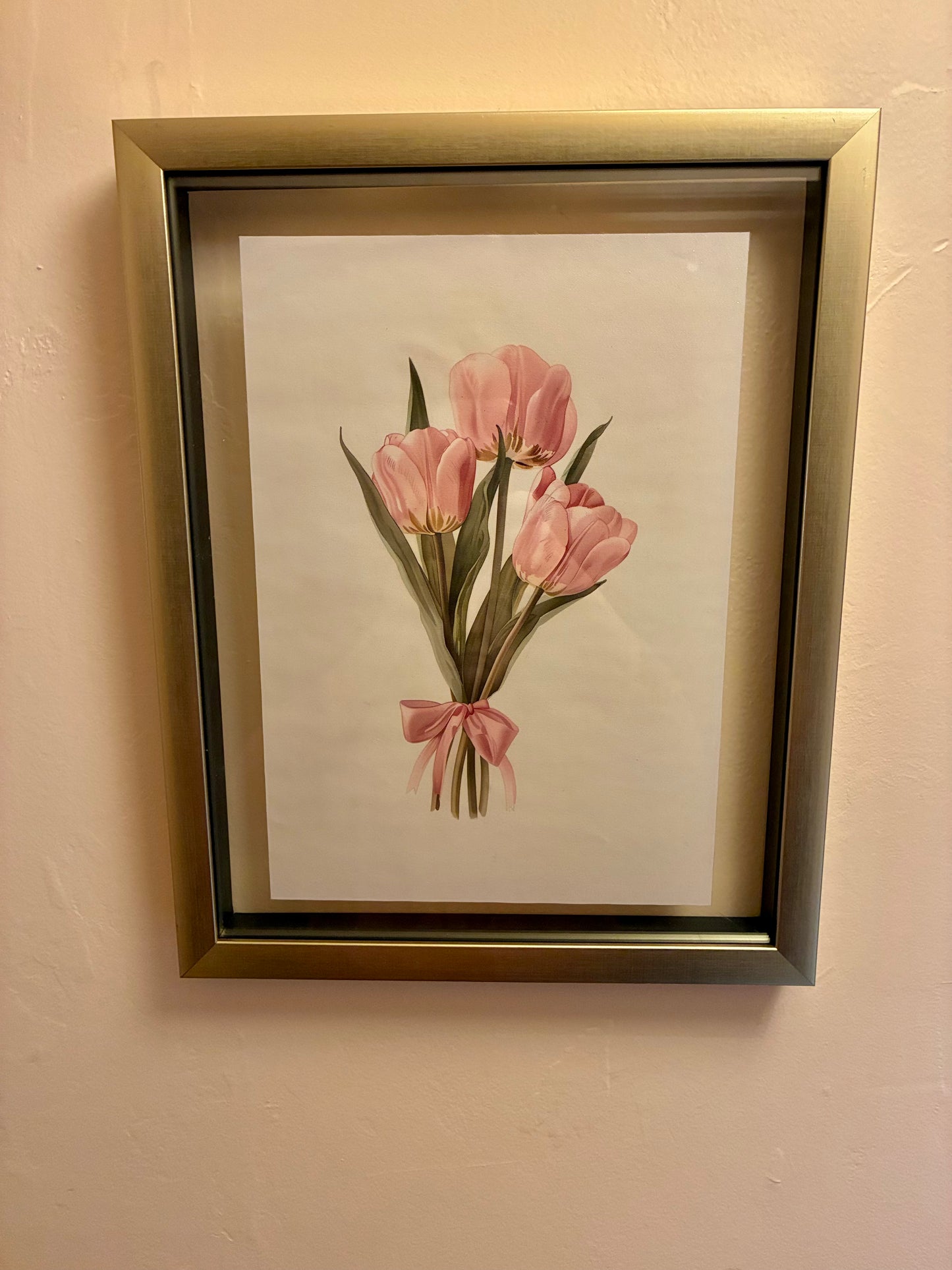 Pink tulips and ribbon canvas print in floating gold frame