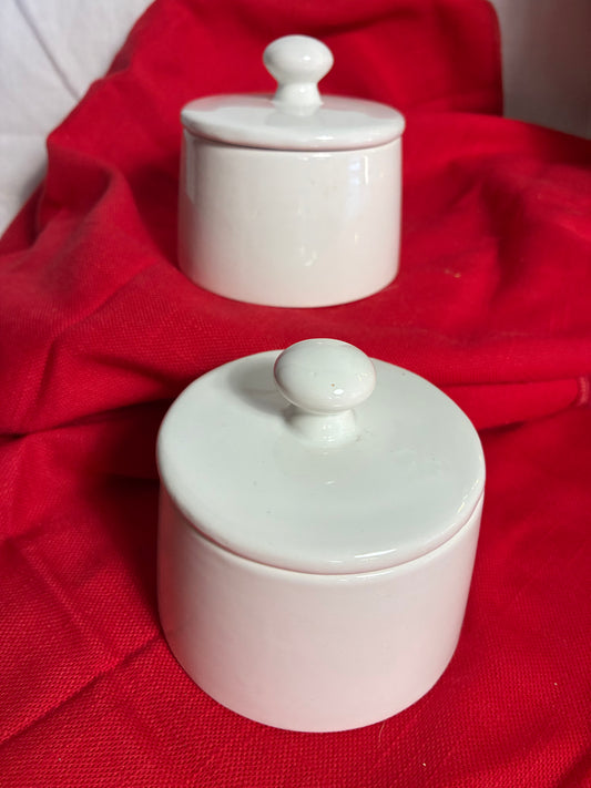 Pair of sleek white canisters