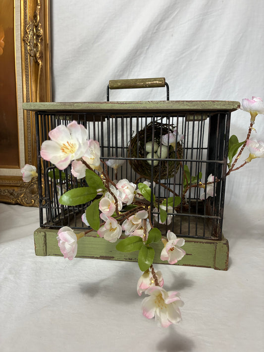 Vintage wore and wood birdcage with floral decor